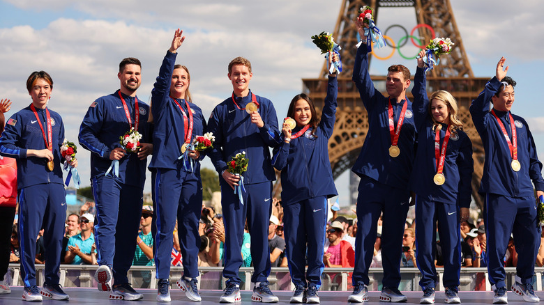 U.S. Figure Skating Team waving with their medals in front of the Eiffel Tower