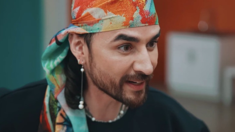A close-up of Antonio Estrada speaking to a model on season 21 of "Project Runway"