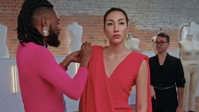 Christian Siriano watches Prajjé Oscar Jean-Baptiste dress a model in a pink gown during "Project Runway" season 20