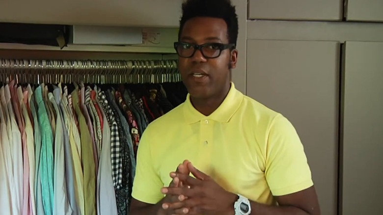 "Project Runway All Stars" contestant Stanley Hudson wears a yellow polo while giving a closet tour
