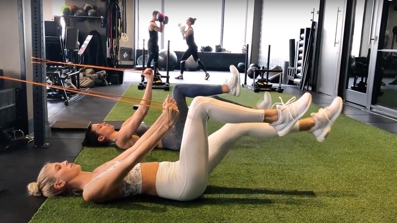 Devon Windsor working out in gym with exercise band