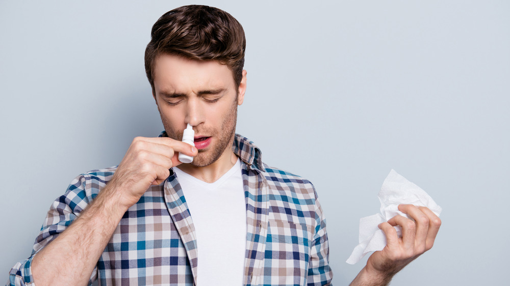 Man using nasal spray