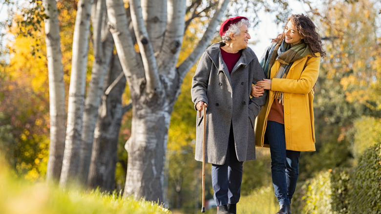 An older and younger woman walking 