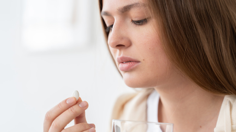 woman holding birth control pills