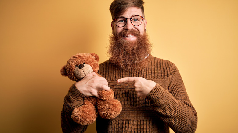 Man pointing to teddy bear