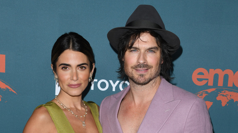 Nikki Reed and Ian Somerholder posing at an event