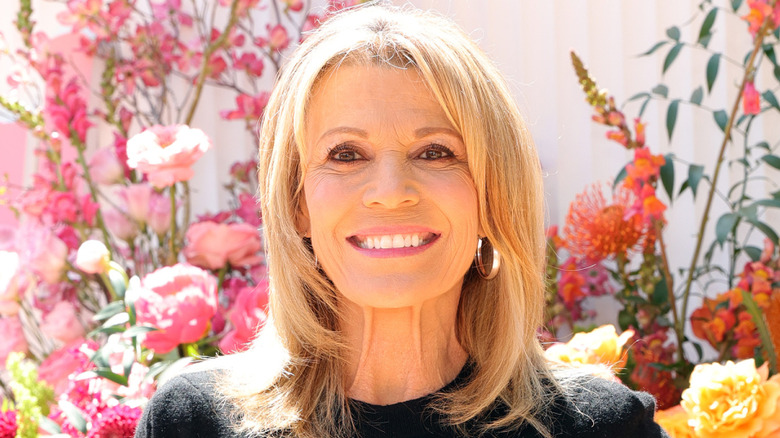 Vanna White standing in front of flowers