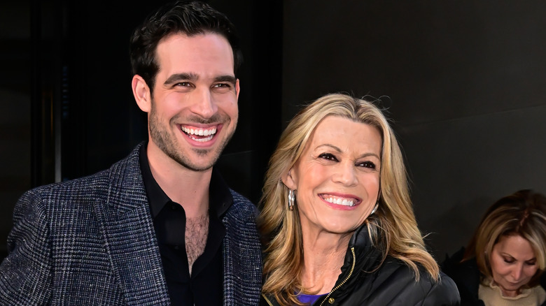 Niko Santo Pietro in a suit next to Vanna White