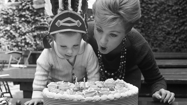 Shaun Cassidy and Shirley Jones blowing out candles on a birthday cake