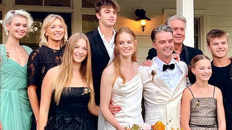 Tracey Lynne Turner, Shaun, Juliet, Caleb, Roan, Lila, Mairin Cassidy smiling at Jake and Georgie Cassidy's wedding in 2023