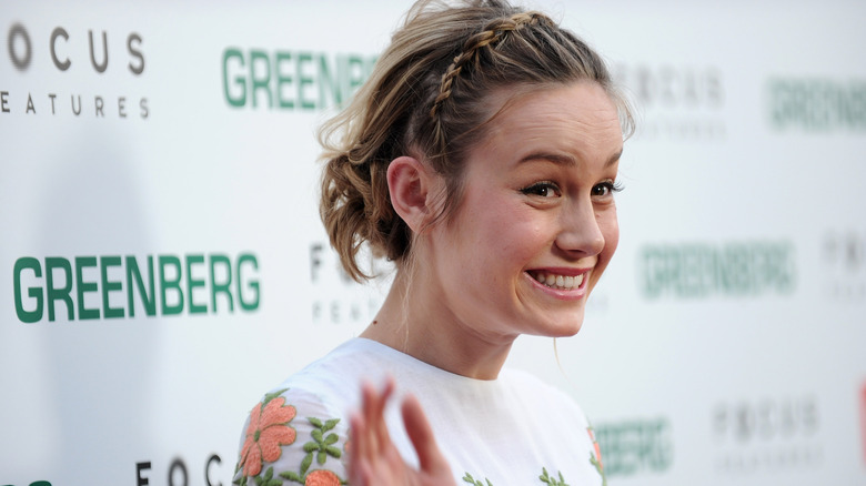 Brie Larson smiling at a premiere event for Greenberg