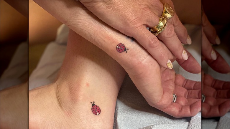 Brooke Shields and Rowan Henchy show off their matching lady bug tattoos on their wrist and foot