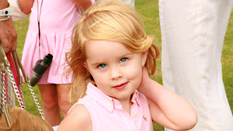 Rowan Henchy poses as a toddler wearing a pink dress