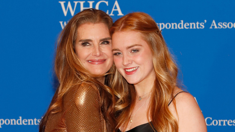 Rowan Henchy poses with her mom, actor Brooke Shields, with their heads together on the red carpet before the White House Correspondents' Dinner
