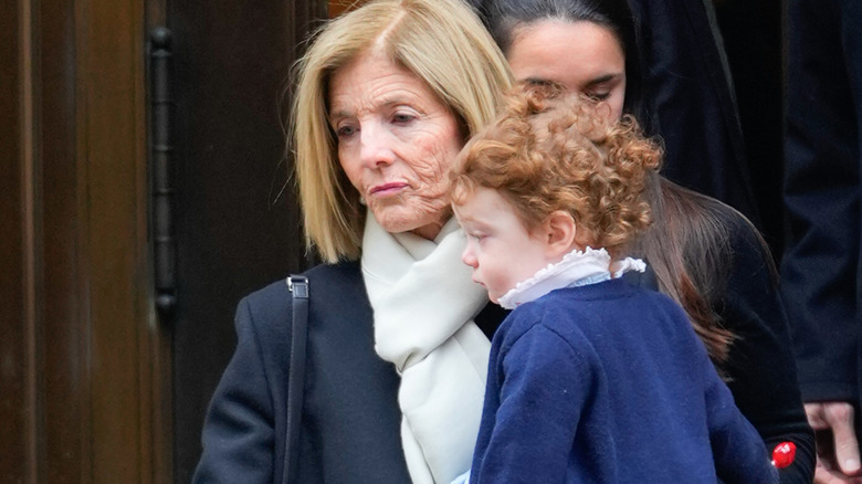 Caroline Kennedy holding Josephine Moran at Tatiana Schlossberg's funeral