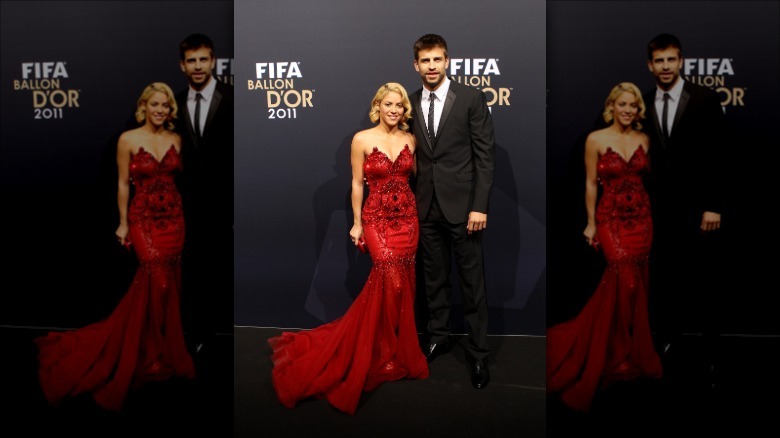 Shakira and Gerard Piqué posing on a FIFA event red carpet in 2011