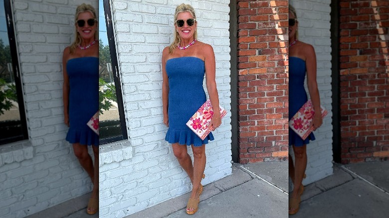 woman posing in blue strapless dress