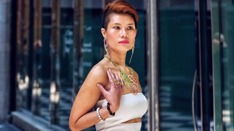 Woman wearing beaded flower necklace and dress