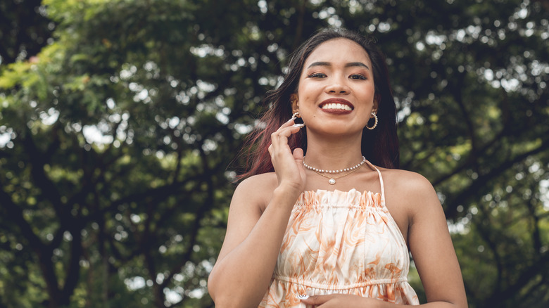 woman wearing orange halter top