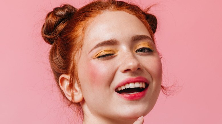 Redheaded woman winking