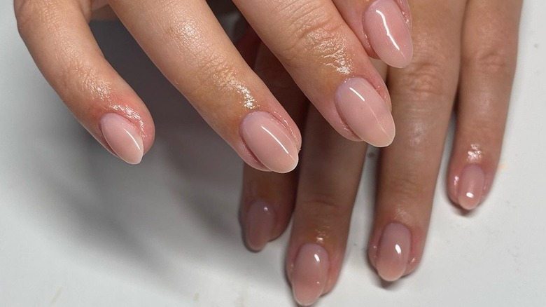 Fingers with milk nails