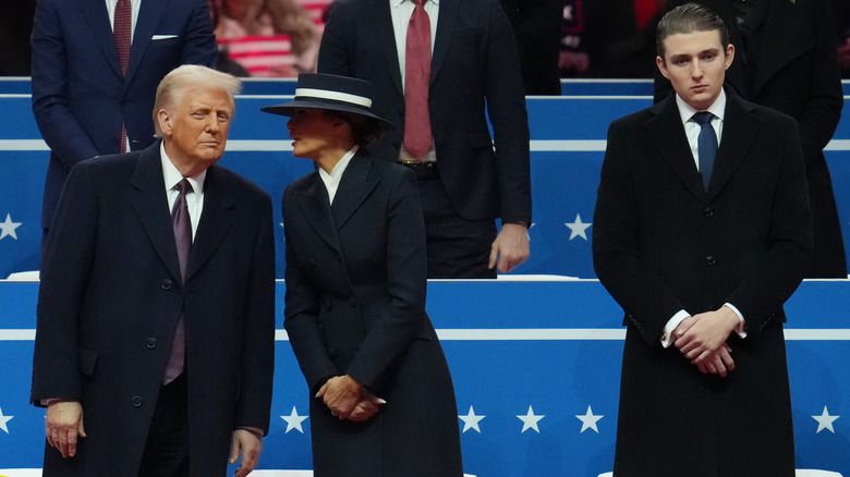 Barron Trump standing apart from Donald and Melania at inaugural parade