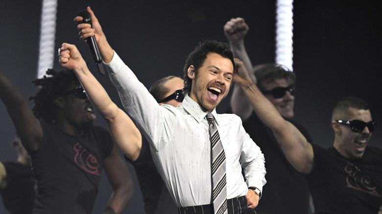 Harry Styles performing in a shirt and tie onstage at the 2026 BRIT Awards.