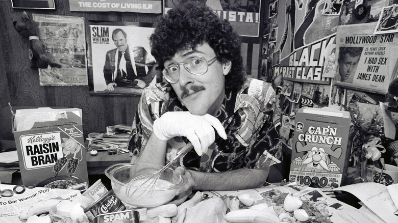 "Weird Al" Yankovic surrounded by posters and cereal boxes.
