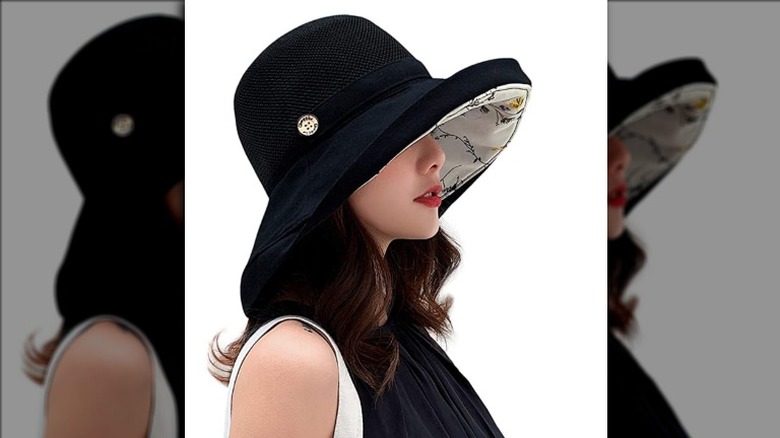 Woman wearing black bucket sun hat with cherry design interior