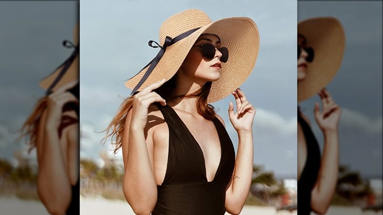 Woman wearing Double Couple wide brim straw hat with thin black bow