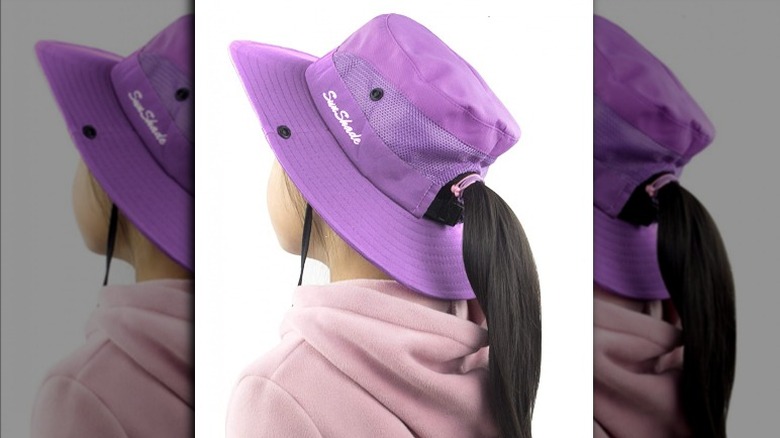 child wearing purple sun hat