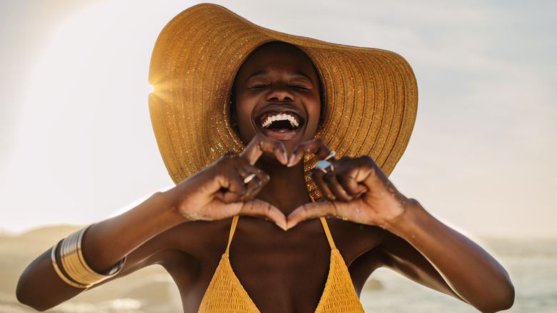 Woman at the beach in a sun hat