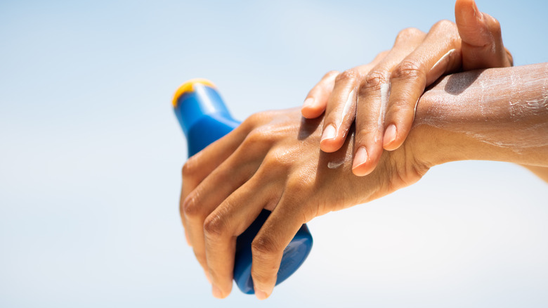 Woman applying sunscreen to her hands