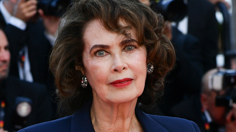 Dayle Haddon staring piercingly into camera and wearing a blue blazer