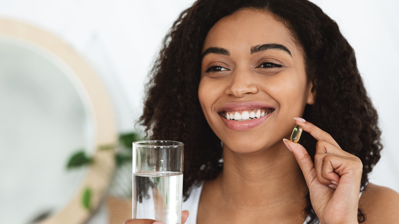 Woman taking a hair supplement