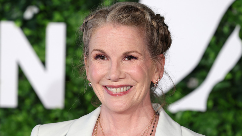 Melissa Gilbert rocking some milk maid braids and a soft pink lip while smiling on the red carpet