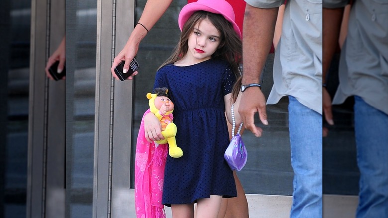 Suri Cruise walking in New York in 2011