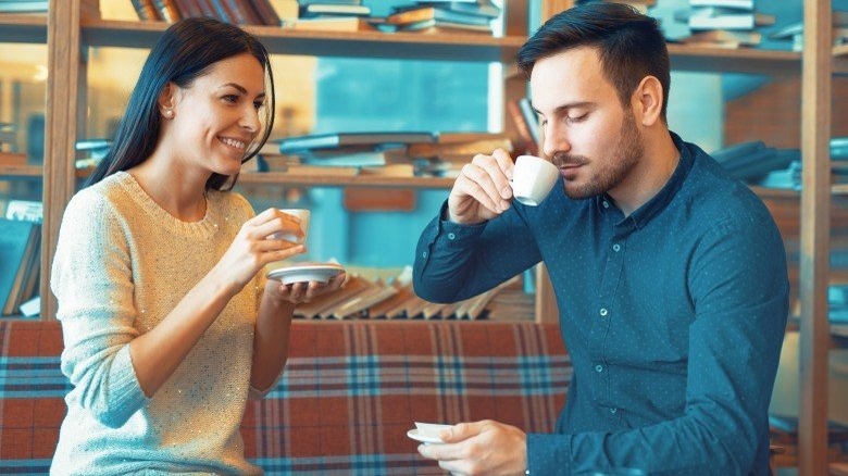 A woman and man having tea