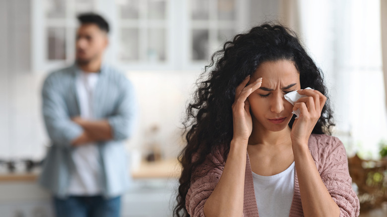 A woman crying in front of a man