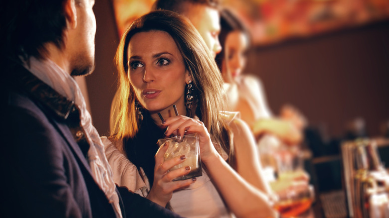 Woman drinking alcohol on a date