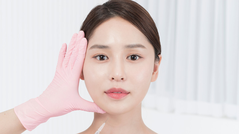 A woman having plastic surgery on her face