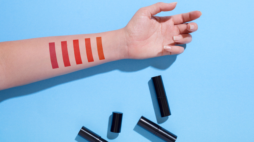 Red lipstick swatches on forearm