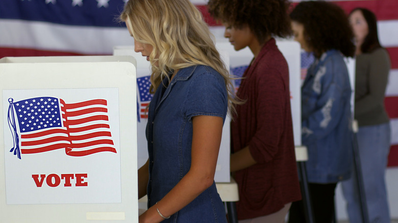 women at voting booths