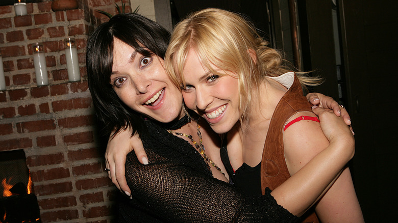 Danielle Brisebois and Natasha Bedingfield smiling and embracing