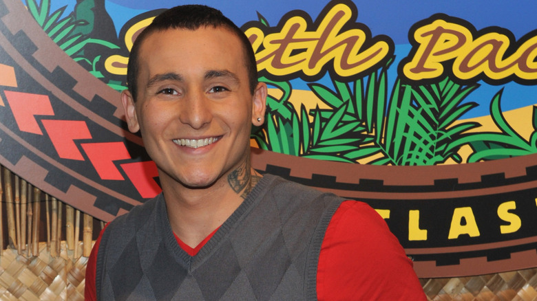 Brandon Hantz posing in front of the Survivor logo