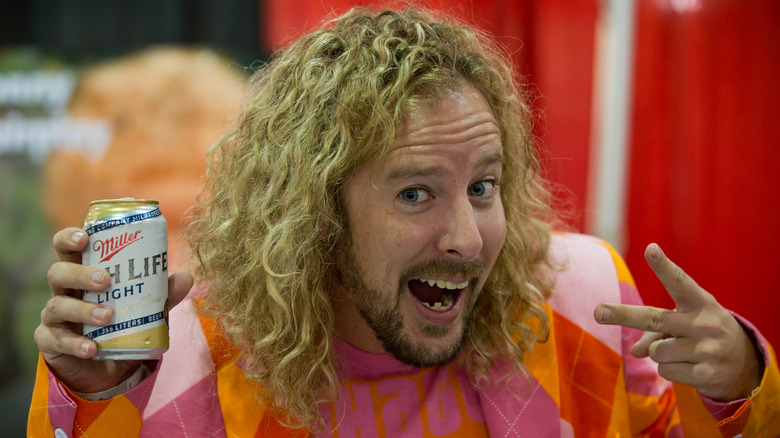 Jon 'Jonny Fairplay' Dalton posing with a can of beer