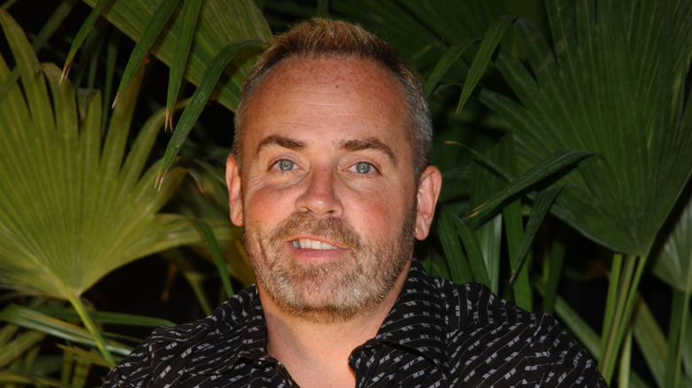 Survivor winner Richard Harch posing in front of a leavesIt's