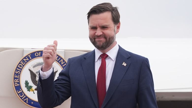 JVD Vance smiling and giving a thumbs-up.