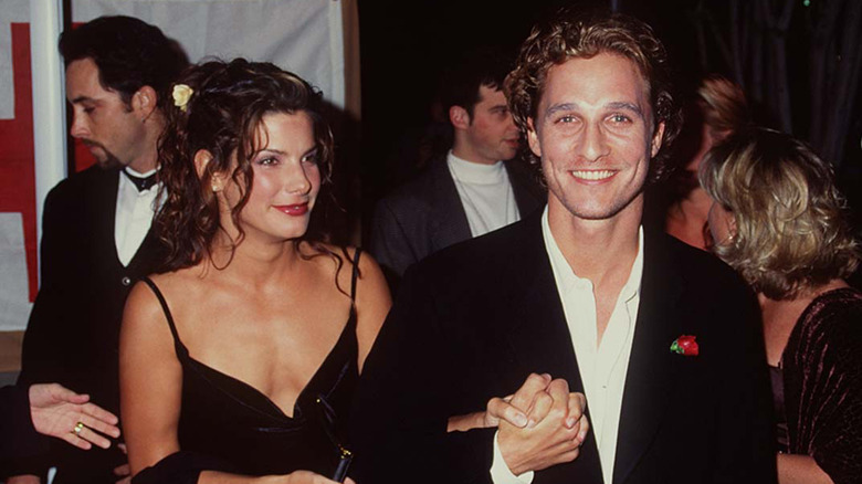 Sandra Bullock and Matthew McConaughey holding hands