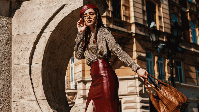 Woman posing outside in leather pencil skirt